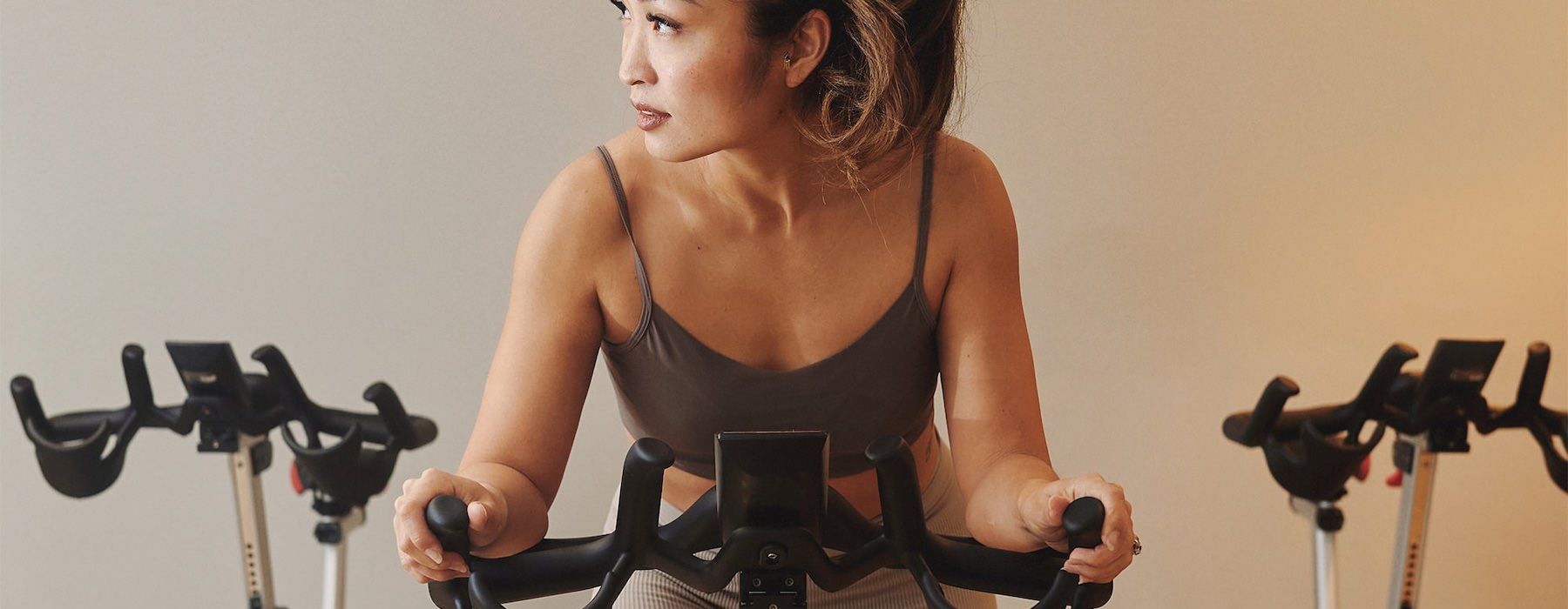 a woman riding a stationary bike